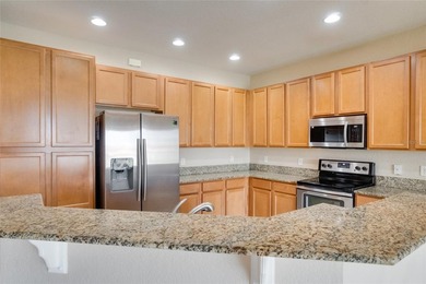 This Eagle Creek townhouse with an upstairs balcony overlooking on Eagle Creek Golf Club in Florida - for sale on GolfHomes.com, golf home, golf lot