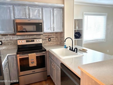 This beautifully updated two-bedroom, two-bath second-floor on Minnesott Golf and Country Club in North Carolina - for sale on GolfHomes.com, golf home, golf lot