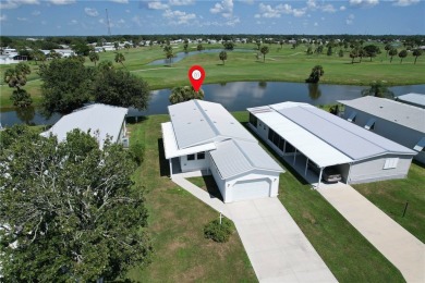 Enjoy direct golf course and water views from this beautifully on Barefoot Bay Golf Course in Florida - for sale on GolfHomes.com, golf home, golf lot