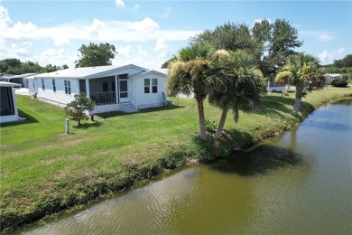 Enjoy direct golf course and water views from this beautifully on Barefoot Bay Golf Course in Florida - for sale on GolfHomes.com, golf home, golf lot