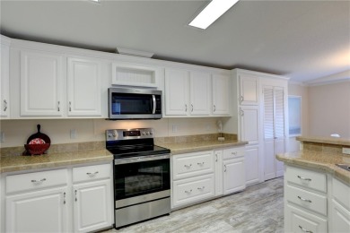 Enjoy direct golf course and water views from this beautifully on Barefoot Bay Golf Course in Florida - for sale on GolfHomes.com, golf home, golf lot