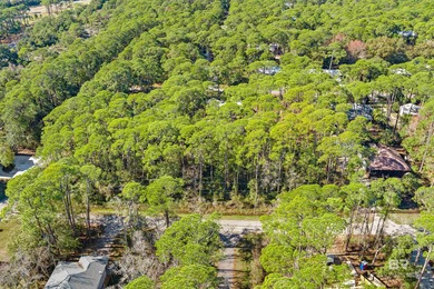Beautiful wooded residential lot on Dauphin Island, measuring on Isle Dauphine Club Golf Course in Alabama - for sale on GolfHomes.com, golf home, golf lot