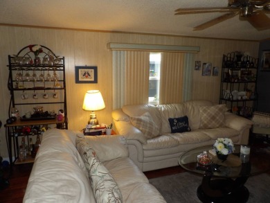 Partially furnished 2 BR 2 BA 14 x 60 mobile home with a 12 X 14 on Crystal Lake Club in Florida - for sale on GolfHomes.com, golf home, golf lot