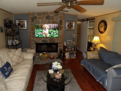 Partially furnished 2 BR 2 BA 14 x 60 mobile home with a 12 X 14 on Crystal Lake Club in Florida - for sale on GolfHomes.com, golf home, golf lot
