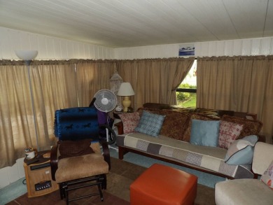 Partially furnished 2 BR 2 BA 14 x 60 mobile home with a 12 X 14 on Crystal Lake Club in Florida - for sale on GolfHomes.com, golf home, golf lot