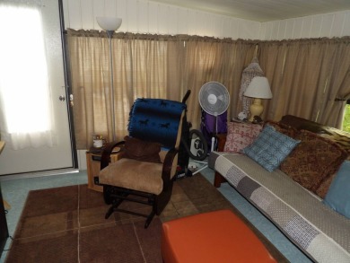 Partially furnished 2 BR 2 BA 14 x 60 mobile home with a 12 X 14 on Crystal Lake Club in Florida - for sale on GolfHomes.com, golf home, golf lot