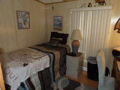 Partially furnished 2 BR 2 BA 14 x 60 mobile home with a 12 X 14 on Crystal Lake Club in Florida - for sale on GolfHomes.com, golf home, golf lot