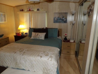 Partially furnished 2 BR 2 BA 14 x 60 mobile home with a 12 X 14 on Crystal Lake Club in Florida - for sale on GolfHomes.com, golf home, golf lot
