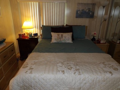 Partially furnished 2 BR 2 BA 14 x 60 mobile home with a 12 X 14 on Crystal Lake Club in Florida - for sale on GolfHomes.com, golf home, golf lot