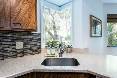 Escape to a peaceful, tree-lined oasis in this beautifully on Palm Harbor Golf Club in Florida - for sale on GolfHomes.com, golf home, golf lot