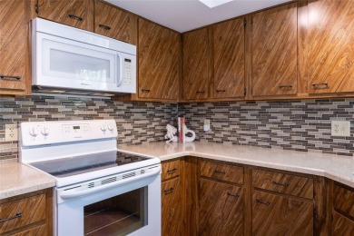 Escape to a peaceful, tree-lined oasis in this beautifully on Palm Harbor Golf Club in Florida - for sale on GolfHomes.com, golf home, golf lot
