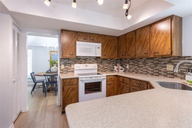 Escape to a peaceful, tree-lined oasis in this beautifully on Palm Harbor Golf Club in Florida - for sale on GolfHomes.com, golf home, golf lot