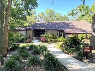 Escape to a peaceful, tree-lined oasis in this beautifully on Palm Harbor Golf Club in Florida - for sale on GolfHomes.com, golf home, golf lot