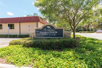 Escape to a peaceful, tree-lined oasis in this beautifully on Palm Harbor Golf Club in Florida - for sale on GolfHomes.com, golf home, golf lot