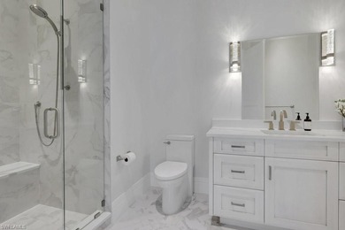 Experience elevated coastal living in this stunning Pelican Bay on Club at Pelican Bay Golf Course in Florida - for sale on GolfHomes.com, golf home, golf lot