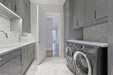 Experience elevated coastal living in this stunning Pelican Bay on Club at Pelican Bay Golf Course in Florida - for sale on GolfHomes.com, golf home, golf lot