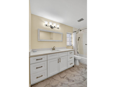 This updated first-floor condo combines comfort, security, and on Atlantis Golf Club in Florida - for sale on GolfHomes.com, golf home, golf lot