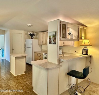 Nestled among the pines, this charming 2-bedroom, 2-bath home on Pine Shadows Golf Course in Arizona - for sale on GolfHomes.com, golf home, golf lot