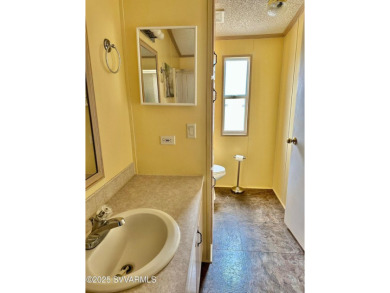 Nestled among the pines, this charming 2-bedroom, 2-bath home on Pine Shadows Golf Course in Arizona - for sale on GolfHomes.com, golf home, golf lot