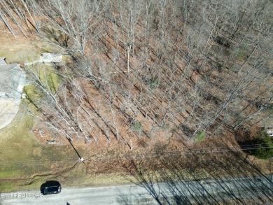 Discover a beautiful gently slopped  wooded lot on a tarred and on Lake Tansi Village Country Club in Tennessee - for sale on GolfHomes.com, golf home, golf lot