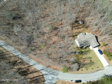Discover a beautiful wooded level lot on a paved road in Lake on Lake Tansi Village Country Club in Tennessee - for sale on GolfHomes.com, golf home, golf lot