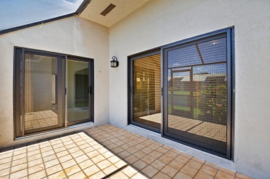 Nestled within a gated community, this 3 bedroom 2.5 bath on Boca Delray Golf and Country Club in Florida - for sale on GolfHomes.com, golf home, golf lot