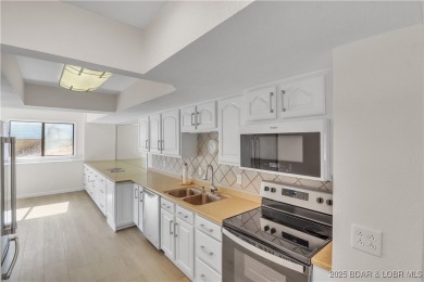 Discover this waterfront retreat with easy walkout to shoreline on Seasons Ridge At Four Seasons in Missouri - for sale on GolfHomes.com, golf home, golf lot