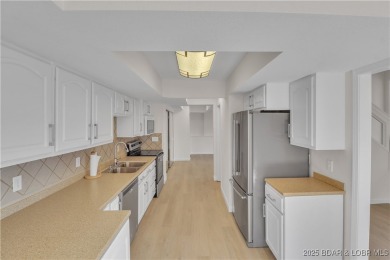 Discover this waterfront retreat with easy walkout to shoreline on Seasons Ridge At Four Seasons in Missouri - for sale on GolfHomes.com, golf home, golf lot