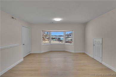 Discover this waterfront retreat with easy walkout to shoreline on Seasons Ridge At Four Seasons in Missouri - for sale on GolfHomes.com, golf home, golf lot