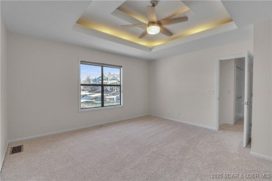 Discover this waterfront retreat with easy walkout to shoreline on Seasons Ridge At Four Seasons in Missouri - for sale on GolfHomes.com, golf home, golf lot