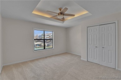 Discover this waterfront retreat with easy walkout to shoreline on Seasons Ridge At Four Seasons in Missouri - for sale on GolfHomes.com, golf home, golf lot