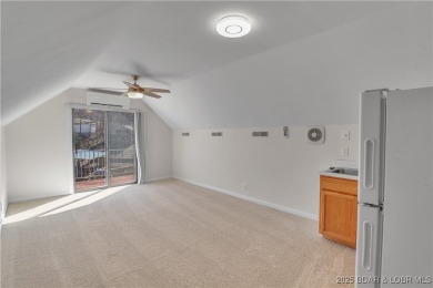 Discover this waterfront retreat with easy walkout to shoreline on Seasons Ridge At Four Seasons in Missouri - for sale on GolfHomes.com, golf home, golf lot