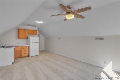 Discover this waterfront retreat with easy walkout to shoreline on Seasons Ridge At Four Seasons in Missouri - for sale on GolfHomes.com, golf home, golf lot