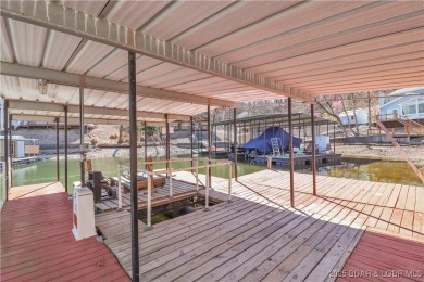 Discover this waterfront retreat with easy walkout to shoreline on Seasons Ridge At Four Seasons in Missouri - for sale on GolfHomes.com, golf home, golf lot