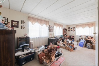 This 2 bedroom, 2 bath home with a covered carport wraps you in on High Point Golf Club, Inc. in Florida - for sale on GolfHomes.com, golf home, golf lot