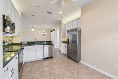 This lovely home is located just steps away from the Valencia on Caloosa Greens Executive Golf Course in Florida - for sale on GolfHomes.com, golf home, golf lot