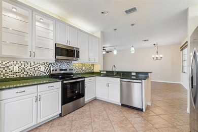 This lovely home is located just steps away from the Valencia on Caloosa Greens Executive Golf Course in Florida - for sale on GolfHomes.com, golf home, golf lot