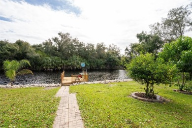 This custom-built, 4-bedroom, solar, waterfront home with a pool on Port Charlotte Golf Club in Florida - for sale on GolfHomes.com, golf home, golf lot