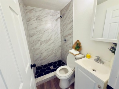 Nestled in the tranquil Edgemoor Estates neighborhood, this cozy on Mangrove Bay Golf Course in Florida - for sale on GolfHomes.com, golf home, golf lot