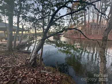 This exceptional waterfront property on Lake Tillery offers on The Tillery Tradition Country Club in North Carolina - for sale on GolfHomes.com, golf home, golf lot