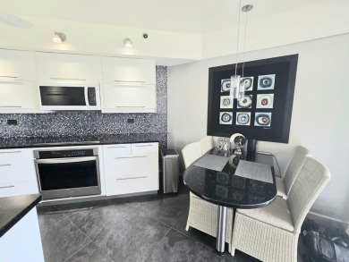 Live in elegance in this beautifully remodeled home in a gated on Inverrary Country Club in Florida - for sale on GolfHomes.com, golf home, golf lot