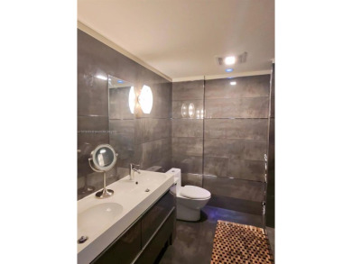 Live in elegance in this beautifully remodeled home in a gated on Inverrary Country Club in Florida - for sale on GolfHomes.com, golf home, golf lot
