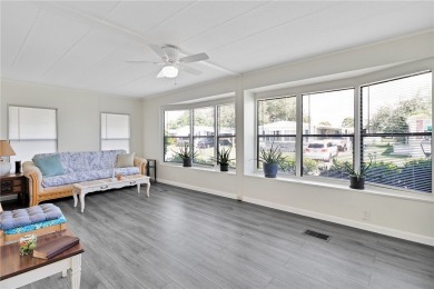 Inviting layout with lots of windows and open floor plan. The on Barefoot Bay Golf Course in Florida - for sale on GolfHomes.com, golf home, golf lot