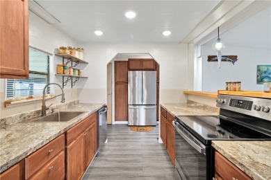 Inviting layout with lots of windows and open floor plan. The on Barefoot Bay Golf Course in Florida - for sale on GolfHomes.com, golf home, golf lot