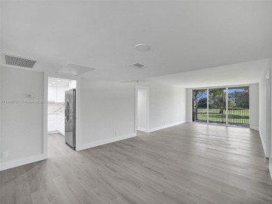Discover luxurious living in this fully renovated 3-bedroom on Palm-Aire Country Club and Resort - The Oaks in Florida - for sale on GolfHomes.com, golf home, golf lot