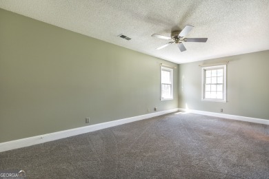 This beautifully updated home is located in a private gated on Canongate At Healy Point Country Club in Georgia - for sale on GolfHomes.com, golf home, golf lot