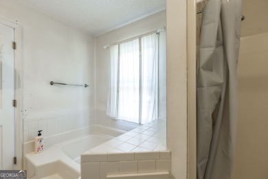 This beautifully updated home is located in a private gated on Canongate At Healy Point Country Club in Georgia - for sale on GolfHomes.com, golf home, golf lot