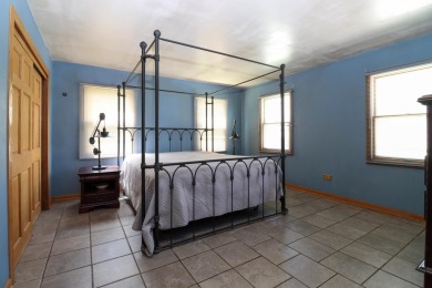 Surrounded by lakes and located on a golf course, this home is on Nippersink Golf Resort in Wisconsin - for sale on GolfHomes.com, golf home, golf lot