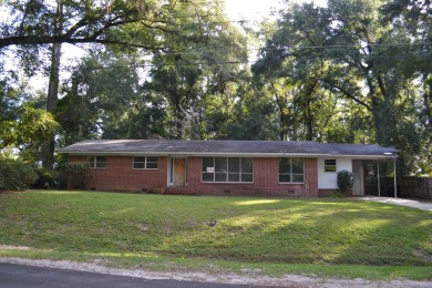 Spacious and full of potential, this 4-bedroom, 2-bathroom home on Jake Gaither Golf Course in Florida - for sale on GolfHomes.com, golf home, golf lot