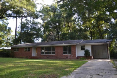 Spacious and full of potential, this 4-bedroom, 2-bathroom home on Jake Gaither Golf Course in Florida - for sale on GolfHomes.com, golf home, golf lot